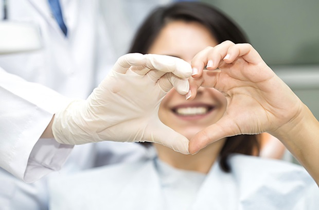 girl smiling with her hands up in a heart