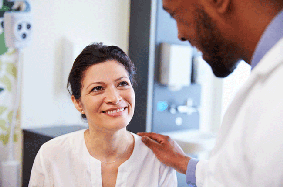 patient and doctor smiling at each other