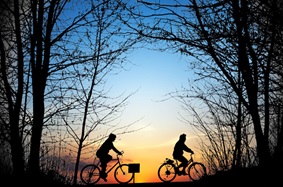 Friends cycling at sunset