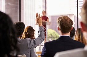 woman speaking to a room full of people