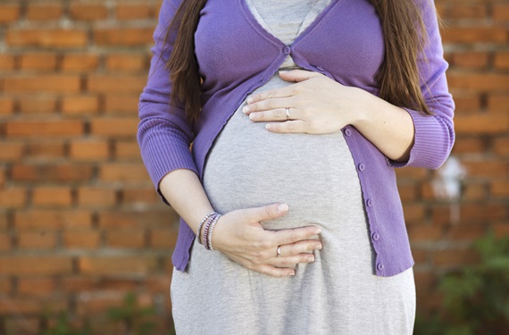 Pregnant woman with hands on belly