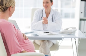 pregnant woman talking to a doctor