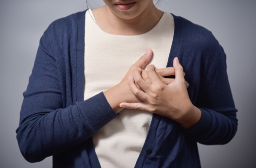 woman holding her hands over her heart
