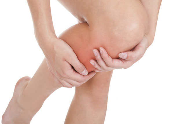 Woman holding her shin