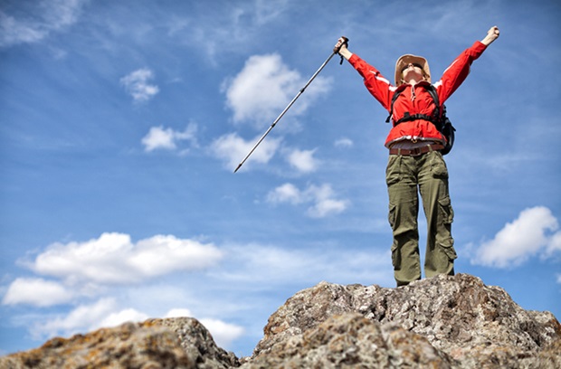 Woman on mountain - survive and thrive