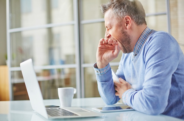man yawning at work