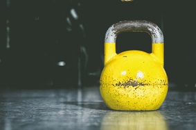 yellow kettle ball on the ground
