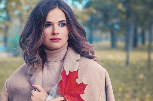 Woman with Fall Leaves in the Autumn Park Outdoors in Sunny Day