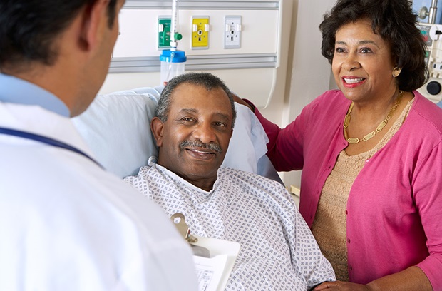 Doctor talking with elderly patient and loved one