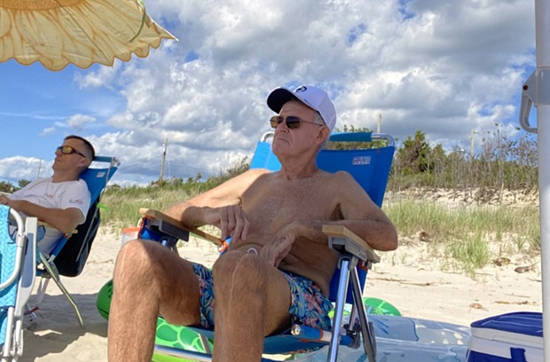 Donald sitting on the beach with family