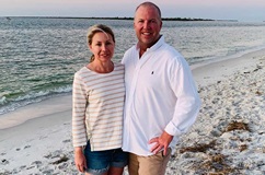 Penn Medicine bariatrics patient Neil Scott stands with his wife on the beach