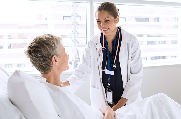 Female doctor smiling with female patient