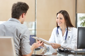 man sitting at female doctor's desk