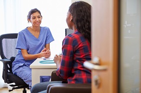 nurse talking to a patient in her office