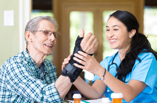Provider holding male patient's wrist brace