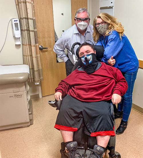 family with young man in wheelchair