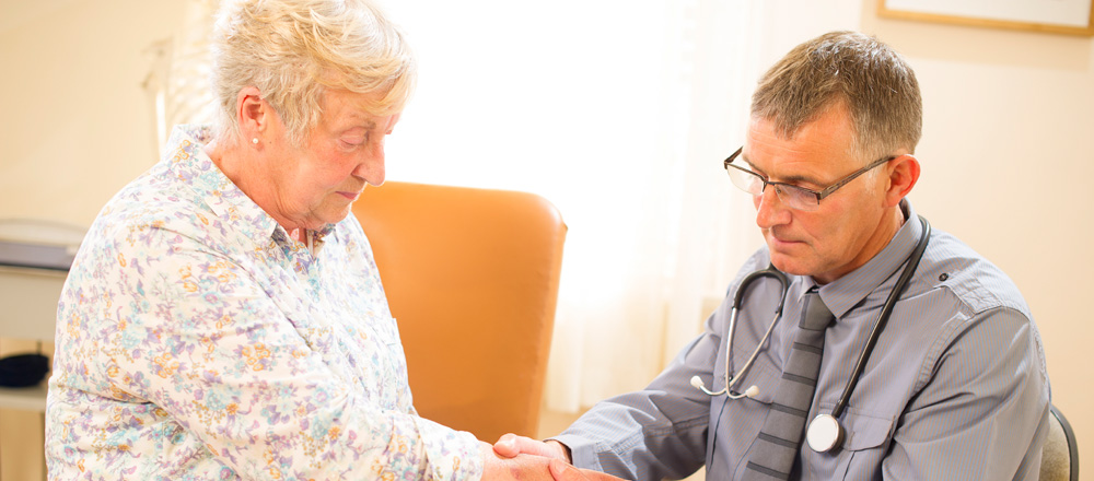 Physician examining woman's hand